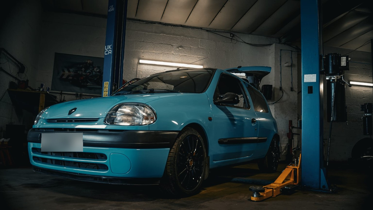 Blue Renault Clio photographed on a lift in the AG Performance workshop